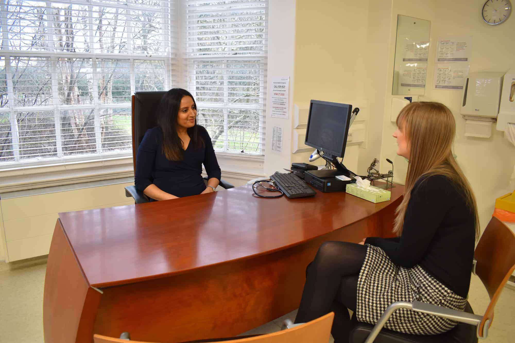 Doctor Rupa discussing medical and corporate services with a client